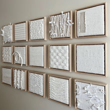 Load image into Gallery viewer, a collection of small square textural white weavings in wood frames
