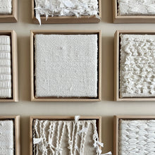 Load image into Gallery viewer, close up of a collection of small square textural white weavings in wood frames
