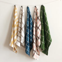 Load image into Gallery viewer, five handwoven cotton teatowels in different colours hang from a clothesline against a white wall
