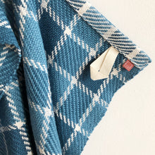 Load image into Gallery viewer, a close-up of a blue checked teatowel showing the tidy hem, cotton loop and small branded tag
