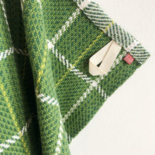 Load image into Gallery viewer, a close-up of a green checked teatowel showing the tidy hem, cotton loop and small branded tag
